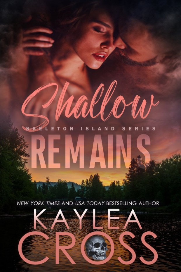 Book cover for 'Shallow Remains' by Kaylea Cross, featuring a romantic image of a couple embracing against a backdrop of a forest and river at sunset, with a skull graphic and text indicating it is part of the Skeleton Island Series.