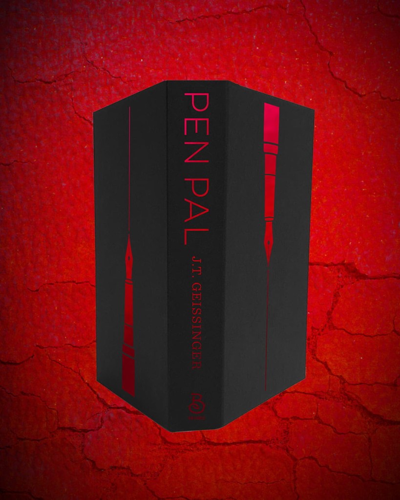 A book titled 'Pen Pal' by J.T. Geissinger, displayed upright with a red and black color scheme, against a textured red background.